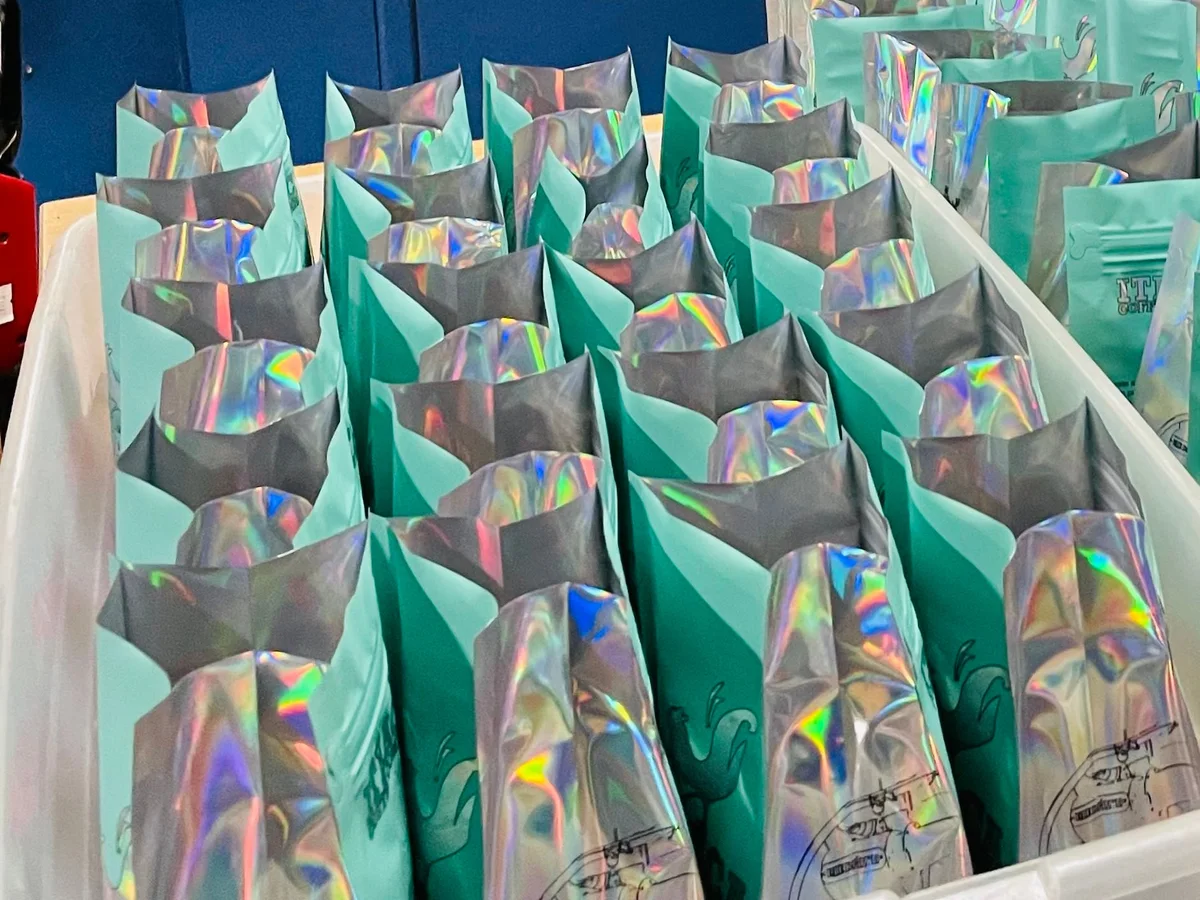 Rows of packed coffee bags in a tray